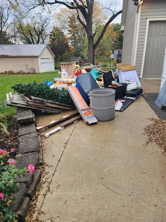 Dumpster being loaded with debris for 10 Yard Dumpster Rental in L'Anse